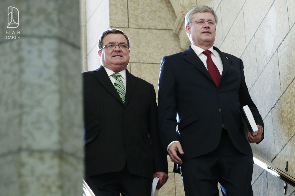 Canada's PM Harper and Finance Minister Flaherty walk to the House of Commons to deliver the budget on Parliament Hill in Ottawa