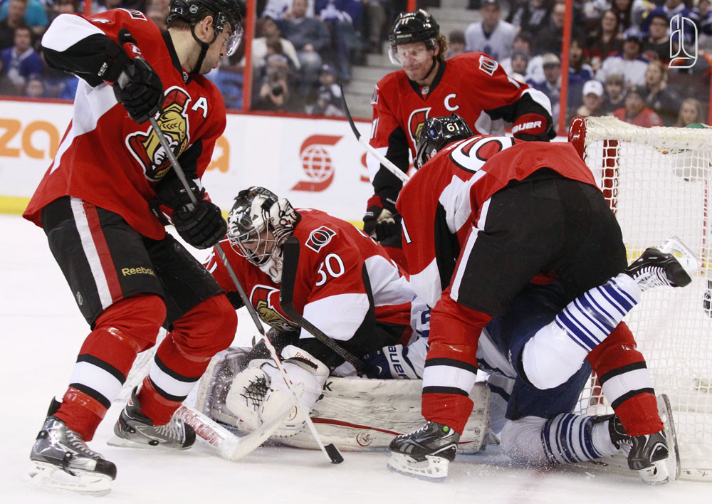 Ottawa Senators' Bishop stops a scoring attempt by Toronto Maple Leafs' MacArthur
